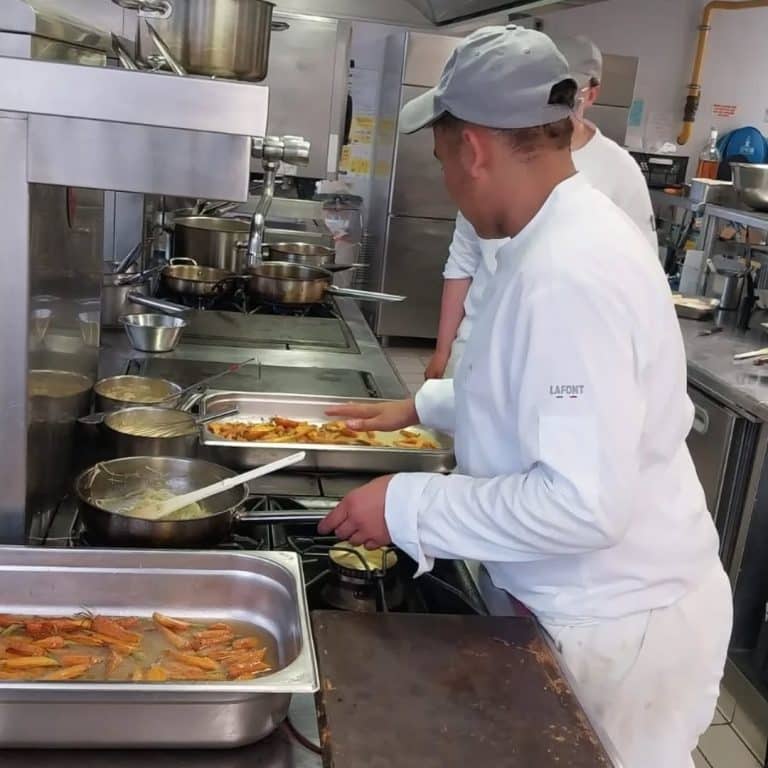 Élève de 1ère Bac Pro CSR Cuisine en préparation culinaire lors de la soirée Bretagne Normandie au lycée L’Amandier